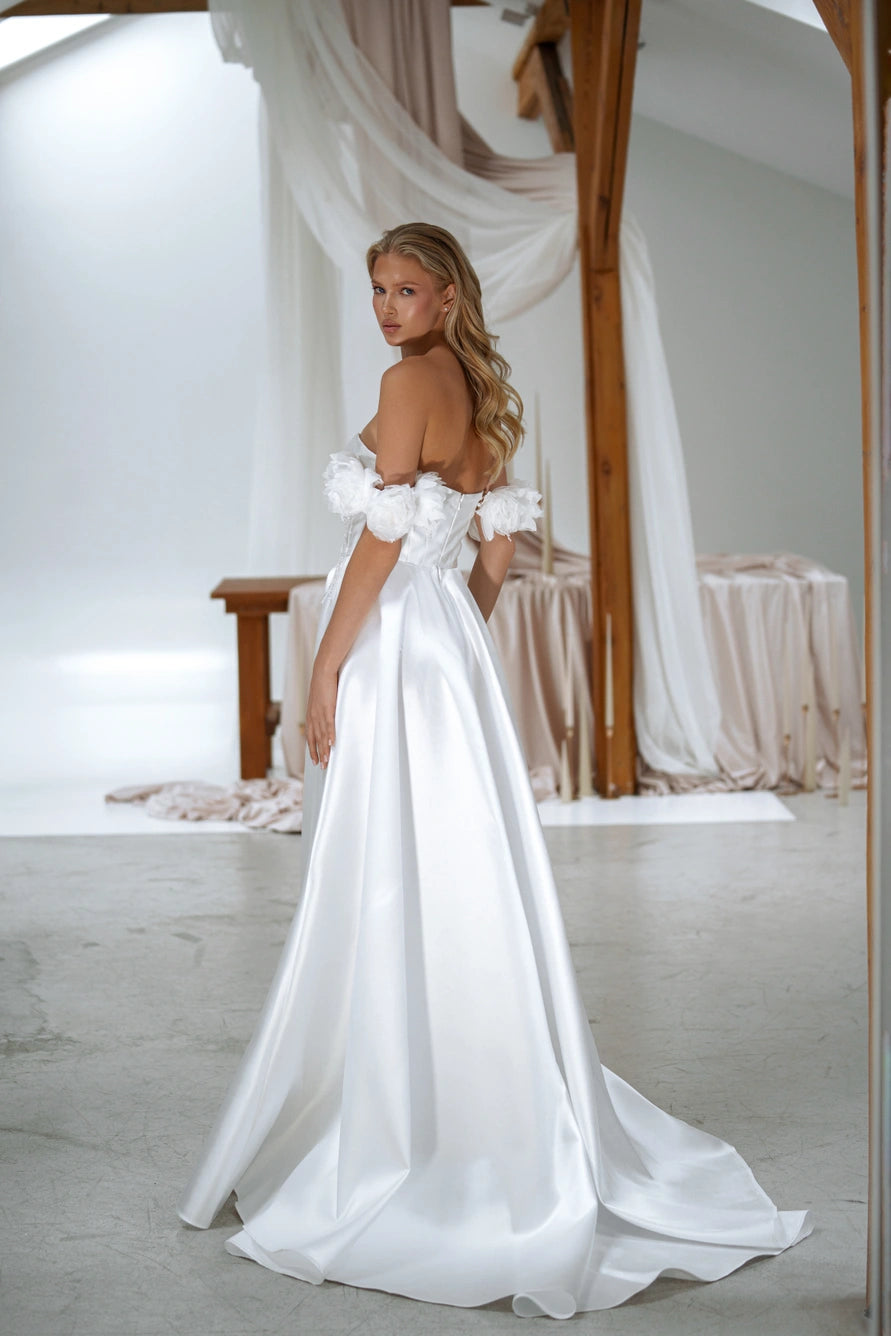 Back view of Scilla wedding dress by Sonya Soley with floral off-shoulder sleeves and satin train