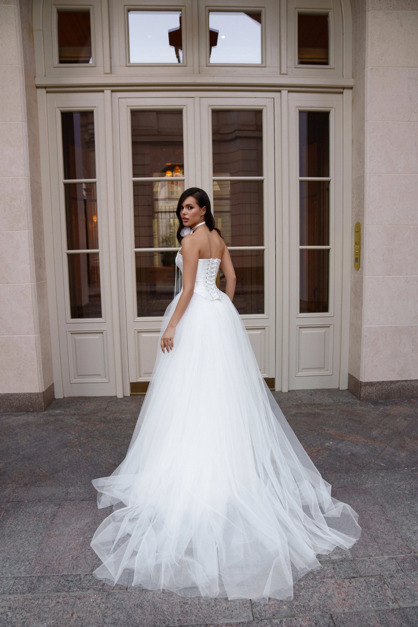 Back view of Limerence wedding dress by Sonesta with lace-up corset and tulle train