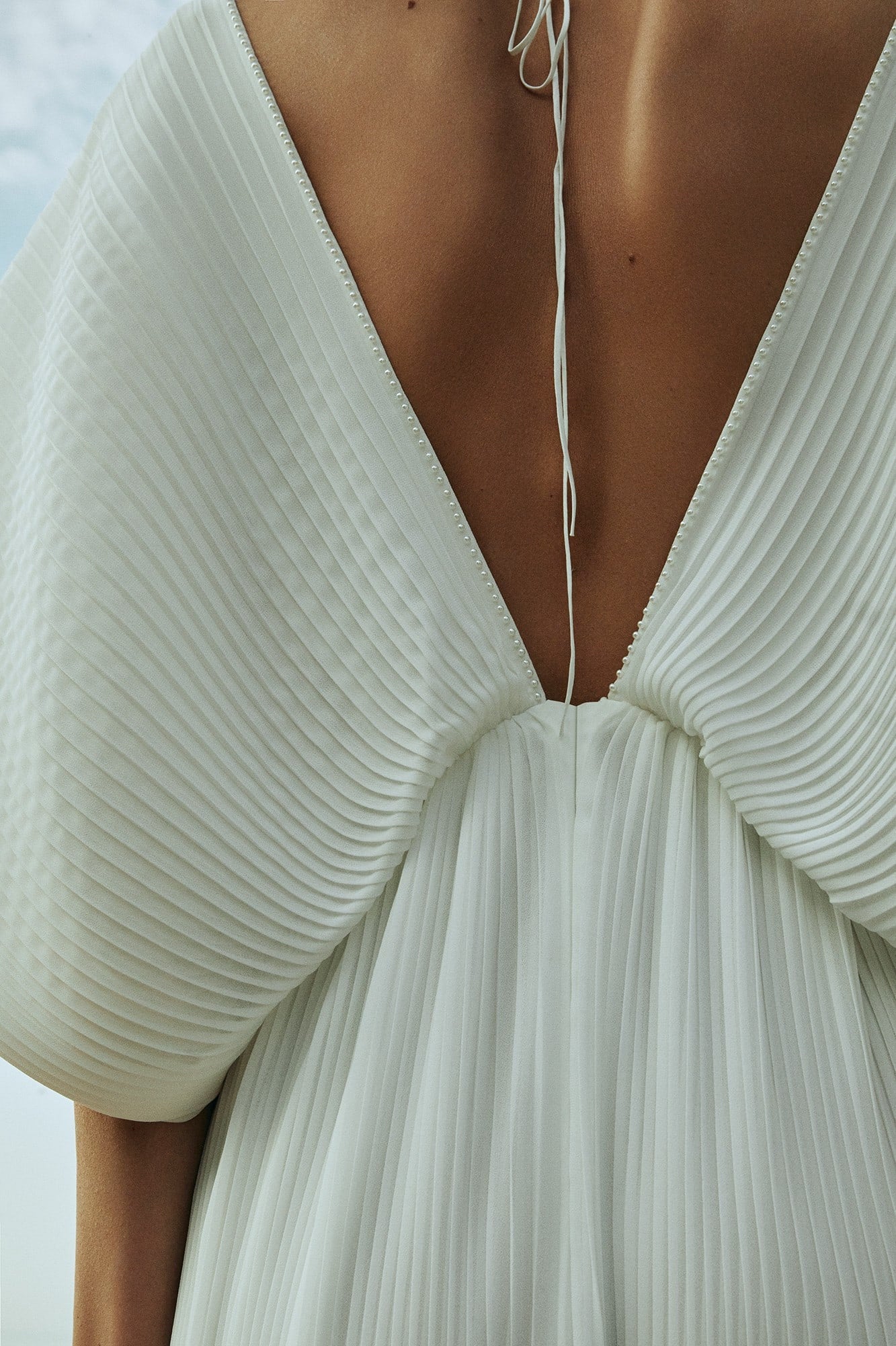 Back view of Seashell Liretta gown with open V‑back to waistline