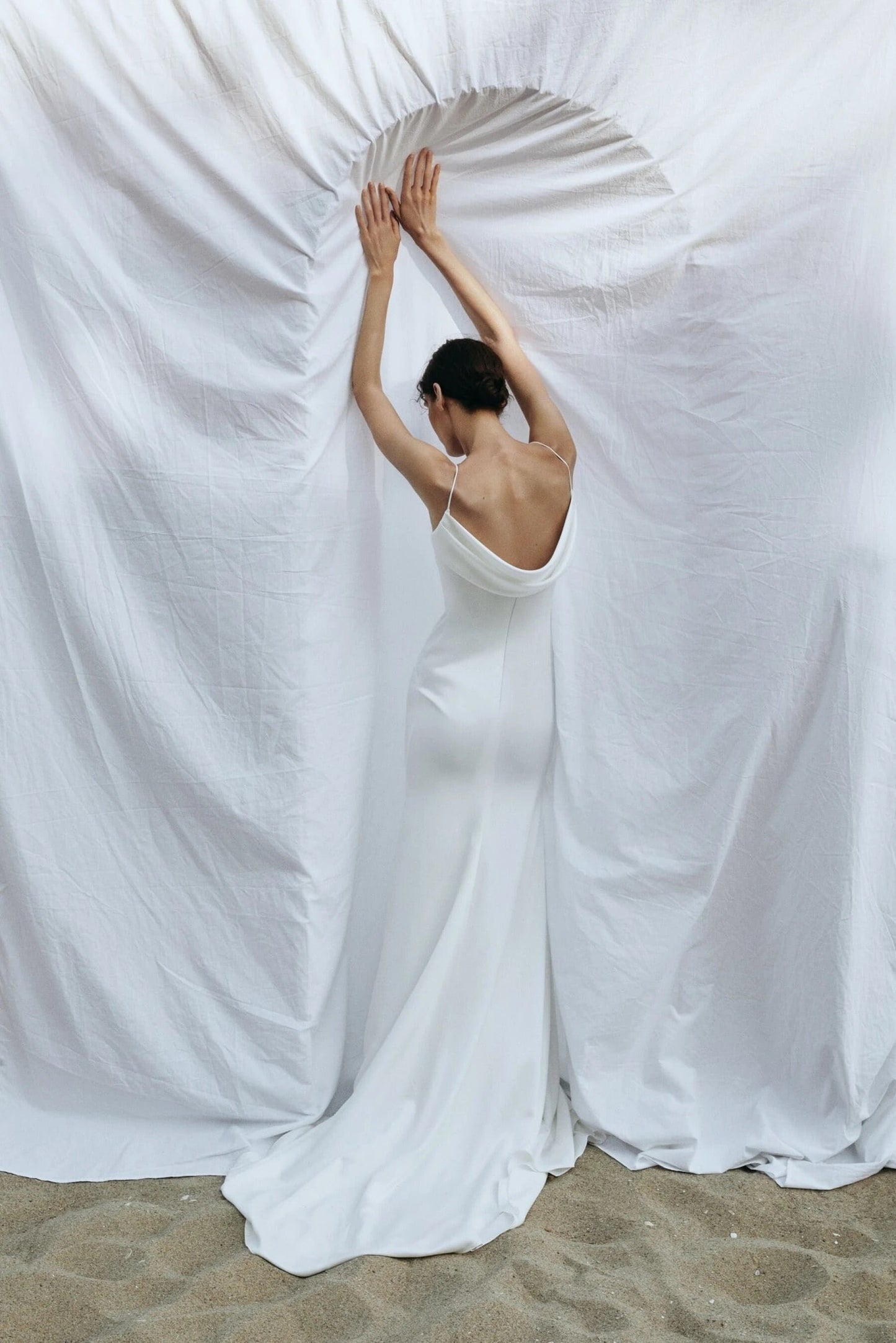 Back view of Liretta Air gown revealing open shoulder‑blade back and sleek train