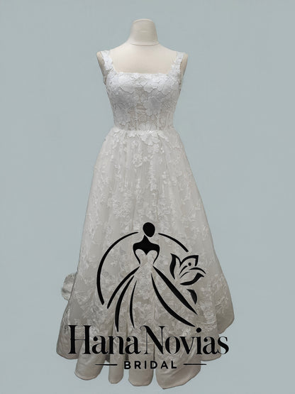 Front view of Lunaria wedding dress by Viva La Pepa with 3D floral lace and sparkling hem detail
