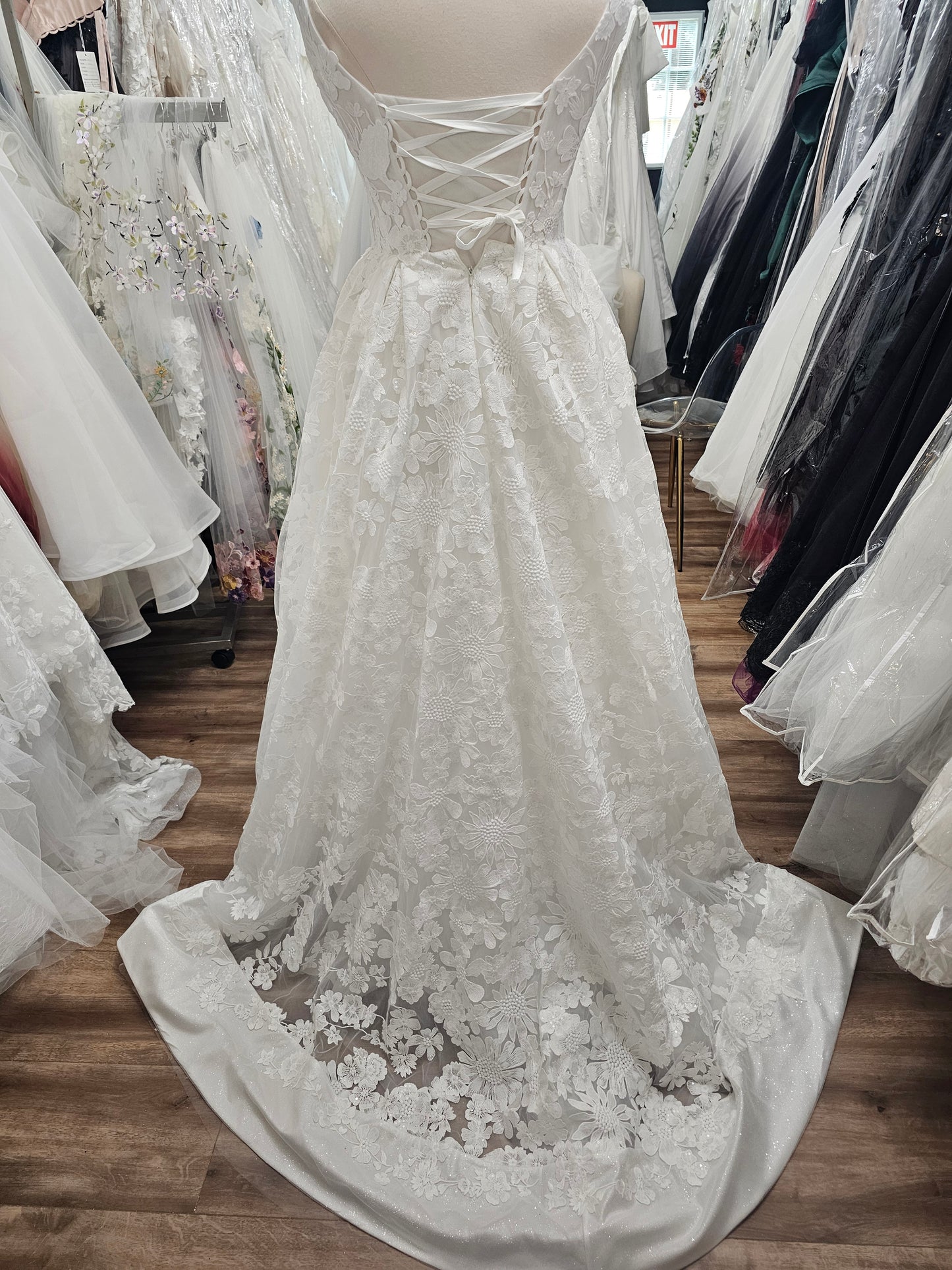 Back view of Lunaria gown featuring lace-up corset bodice and glitter hem