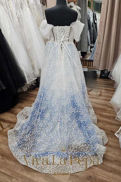 Back view of Estella Luna gown by Viva La Pepa with lace-up corset and floral embroidered tulle train