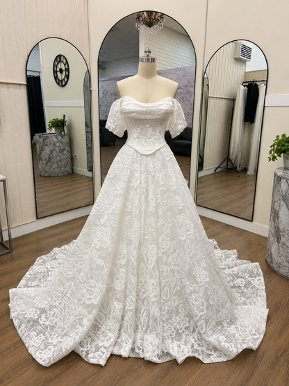 Catalina ivory floral lace wedding dress with off-the-shoulder neckline, basque waist and full bridal skirt