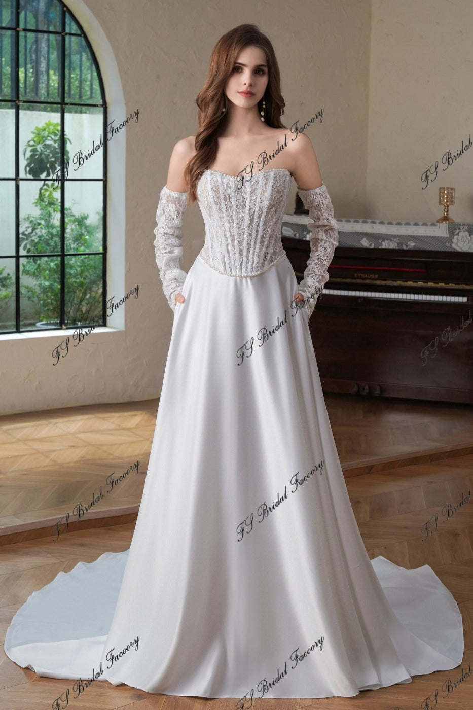 Front view of Eugénie off-shoulder lace corset wedding dress with long lace sleeves and satin A-line skirt with pockets