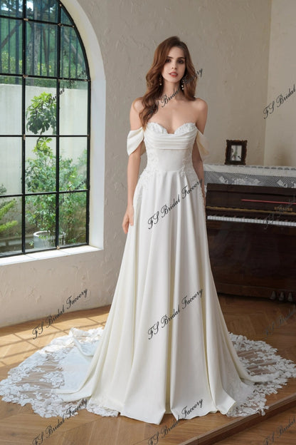 Hélène crepe A-line wedding dress—front view with off-shoulder drape