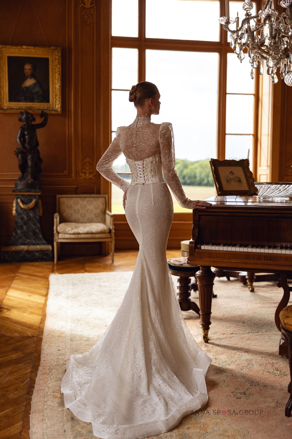 Back view of Klunika gown by Anna Sposa with high-neck lace bolero and fitted skirt