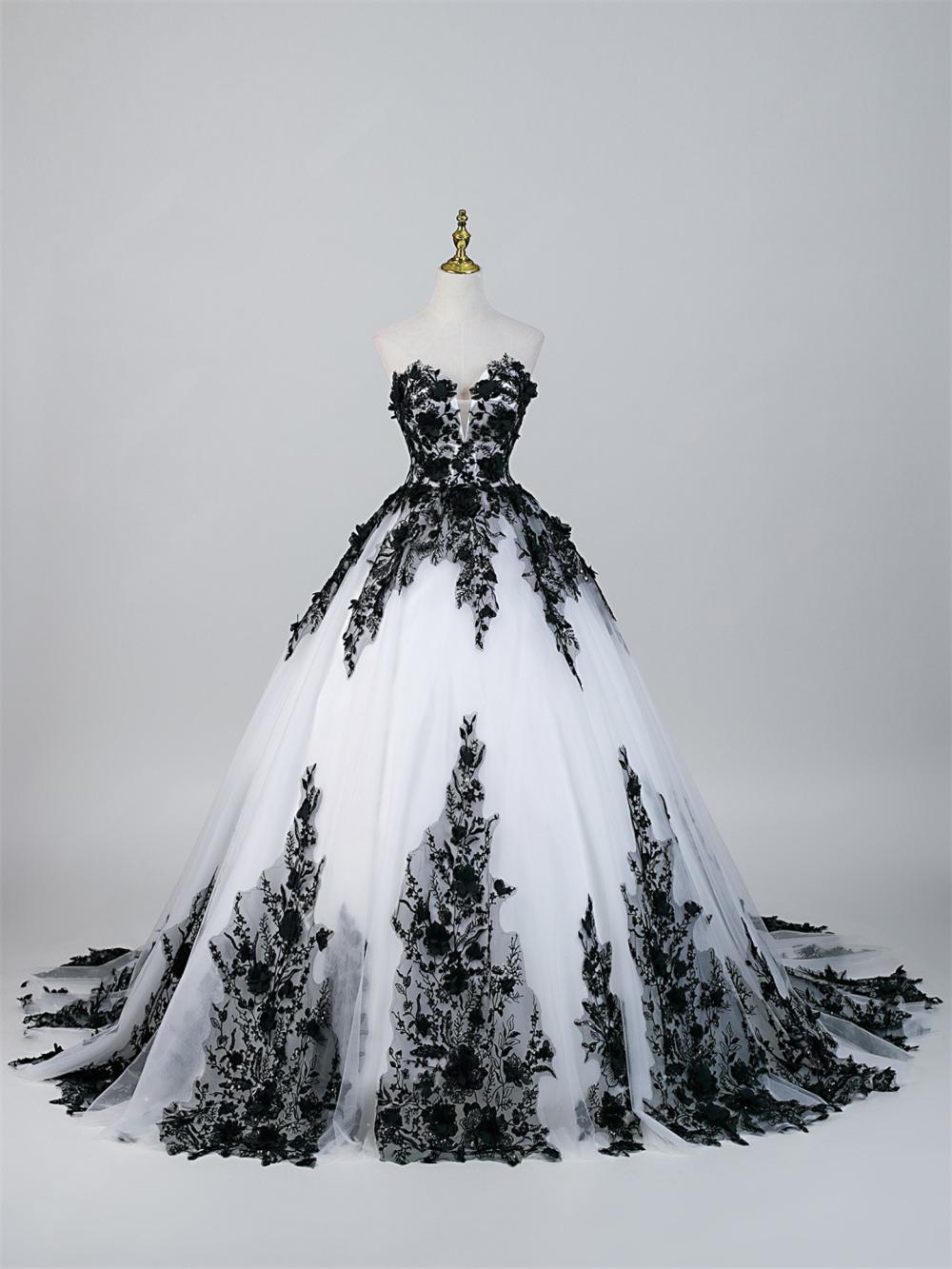 Strapless ivory wedding dress with black lace cascading down skirt