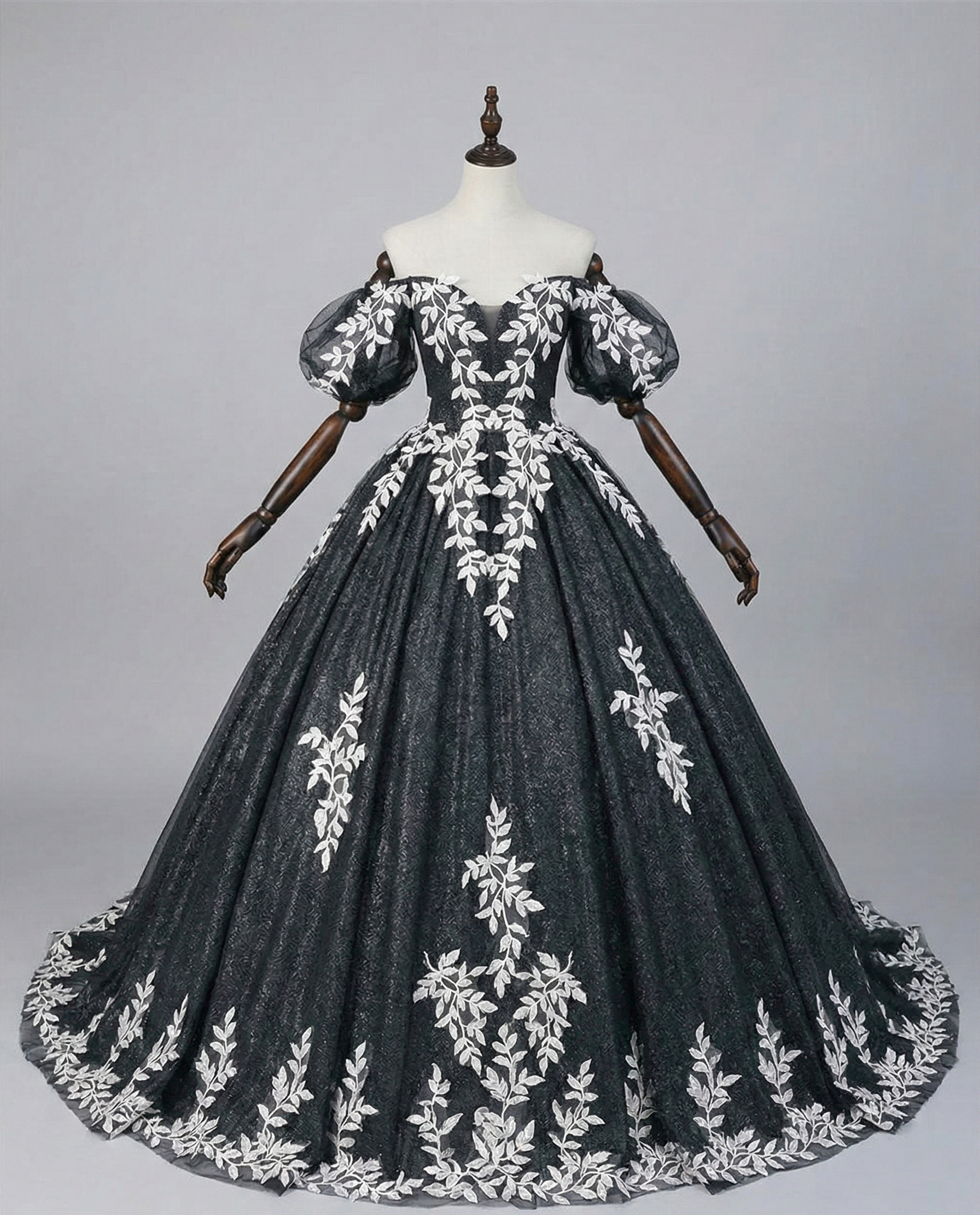 Gothic bridal dress with off-shoulder neckline and dramatic floral border hem