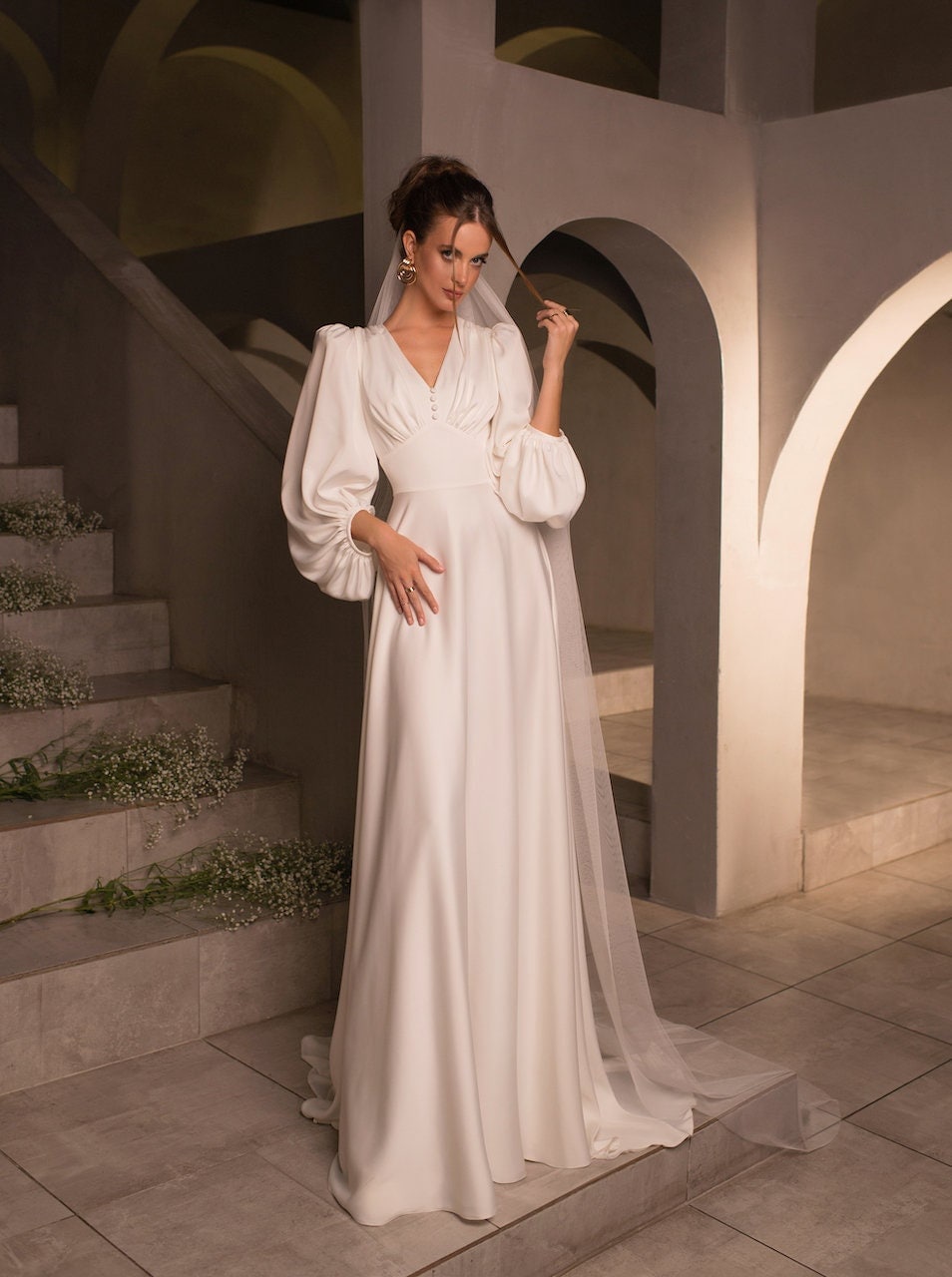 Vintage-Inspired Long-Sleeve Wedding Dress with Puff Sleeves, Deep V-Neckline, and Flowing A-Line Silhouette, Featuring Button Details