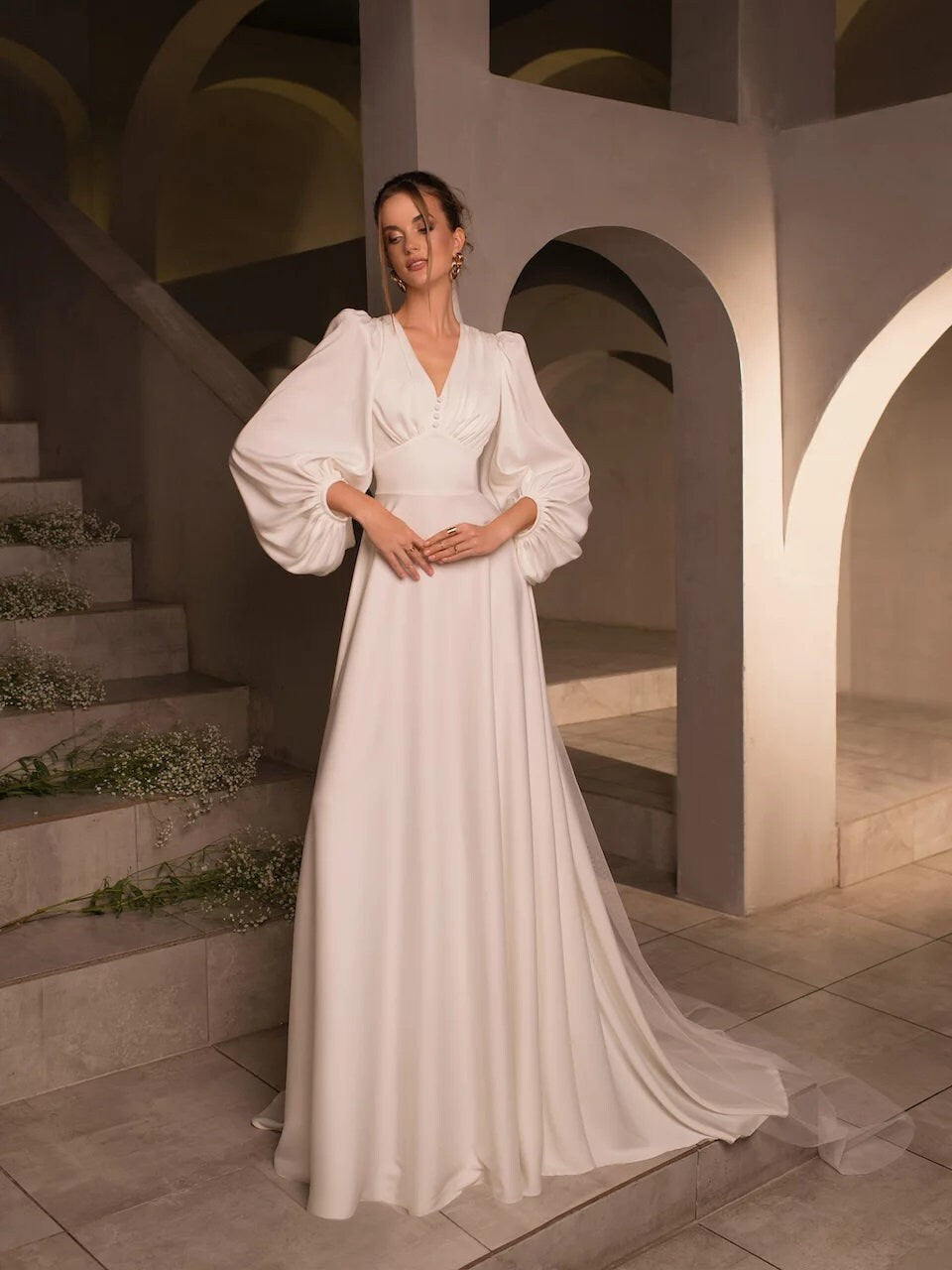 Vintage-Inspired Long-Sleeve Wedding Dress with Puff Sleeves, Deep V-Neckline, and Flowing A-Line Silhouette, Featuring Button Details