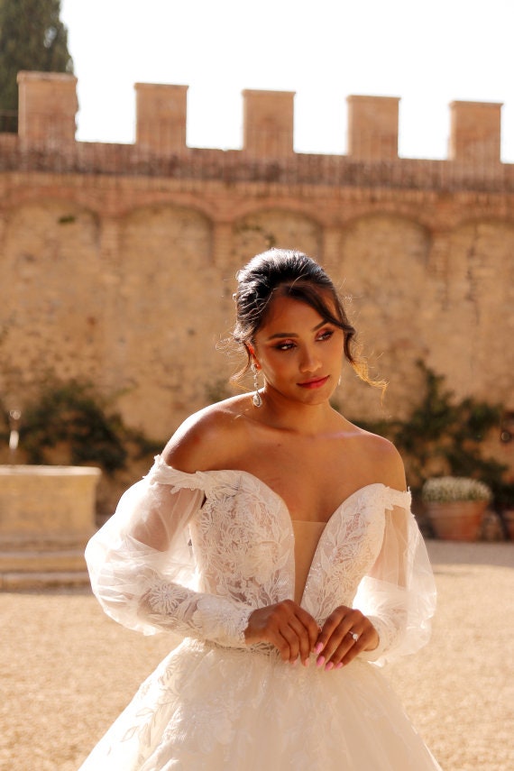 Enchanting Off-Shoulder Tulle Ball Gown Wedding Dress with Plunging Neckline, Detachable Puffy Sleeves, and Delicate Lace Appliqués