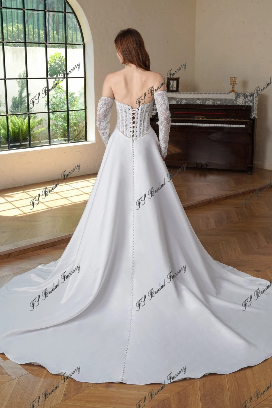 Back view of Eugénie lace-up corset wedding dress with long lace sleeves, button-back satin skirt and chapel train