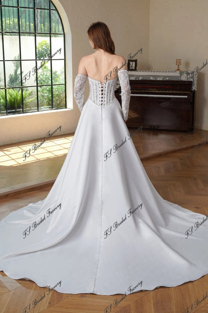 Back view of Eugénie lace-up corset wedding dress with long lace sleeves, button-back satin skirt and chapel train