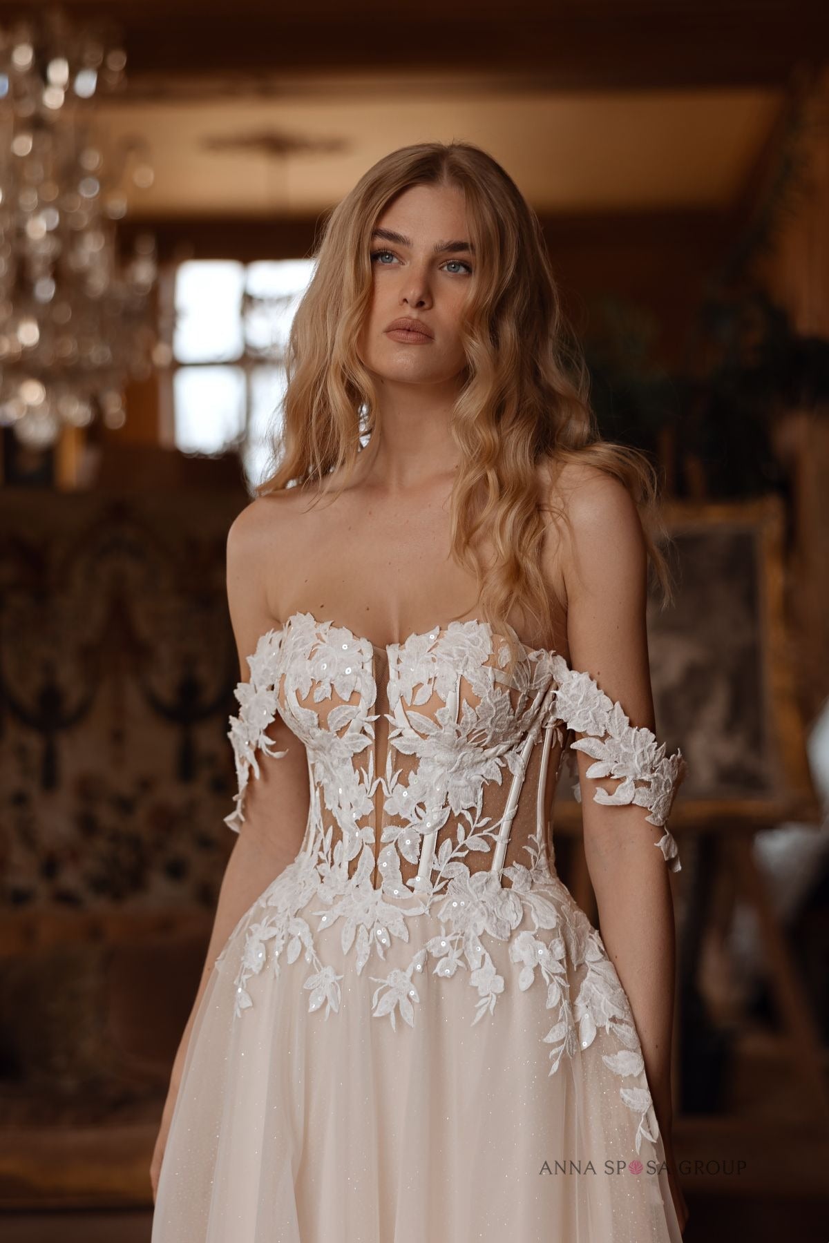 Close-up of Bryaxis wedding dress floral corset bodice with off-the-shoulder lace detailing