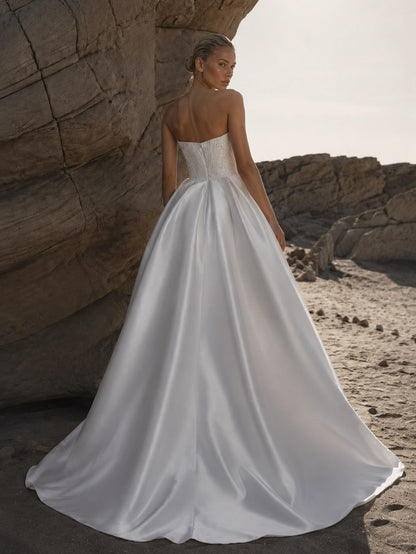 Back of Eniola Natalia Romanova princess wedding dress featuring pearl embellished corset and sweeping satin train