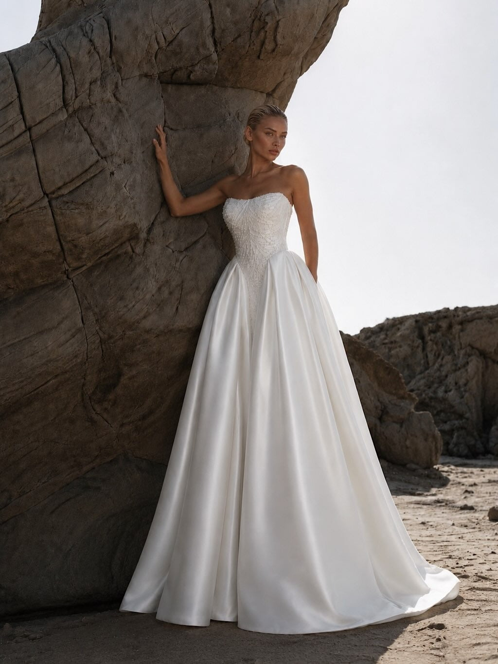 Eniola by Natalia Romanova strapless satin ball gown wedding dress with pearl corset and pointed basque waist