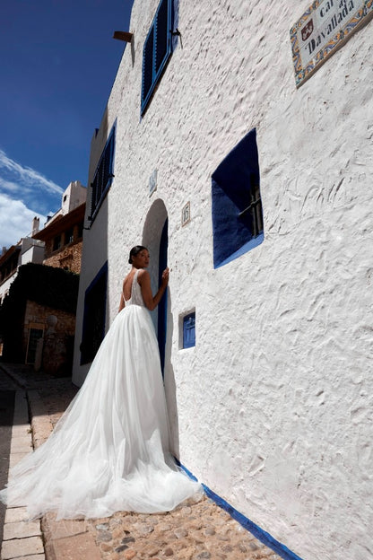 Rear view of Danis dress showcasing open low back and flowing train