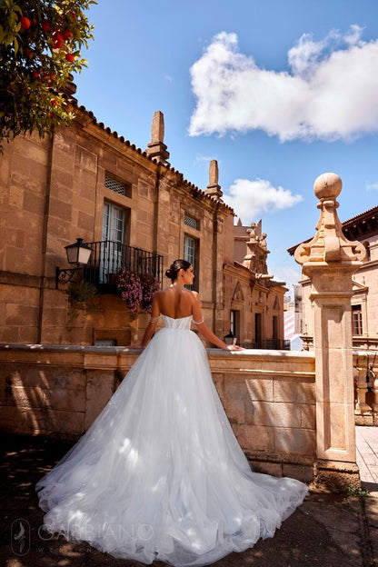 Back view of the Isolda dress with long train and pearl-draped shoulders