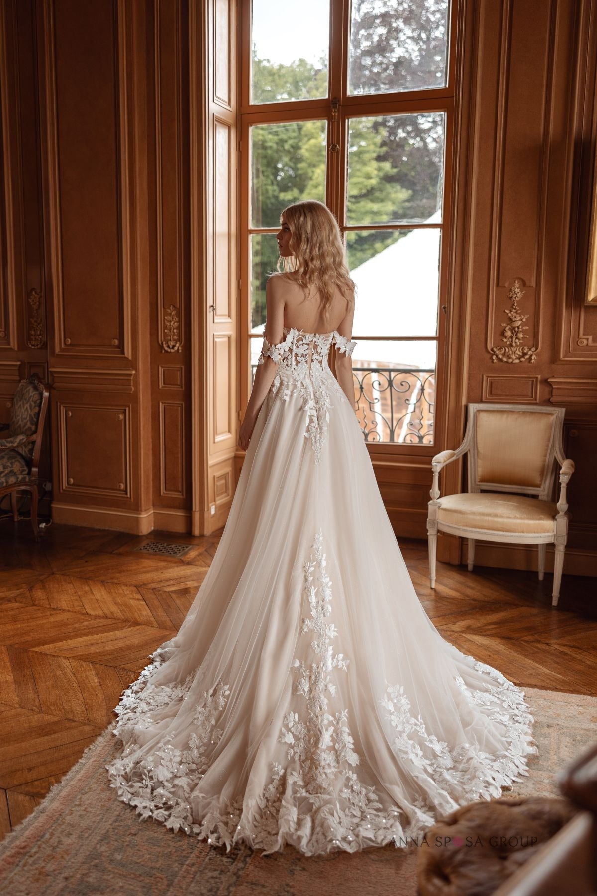 Back view of Bryaxis wedding gown featuring train with floral lace detailing