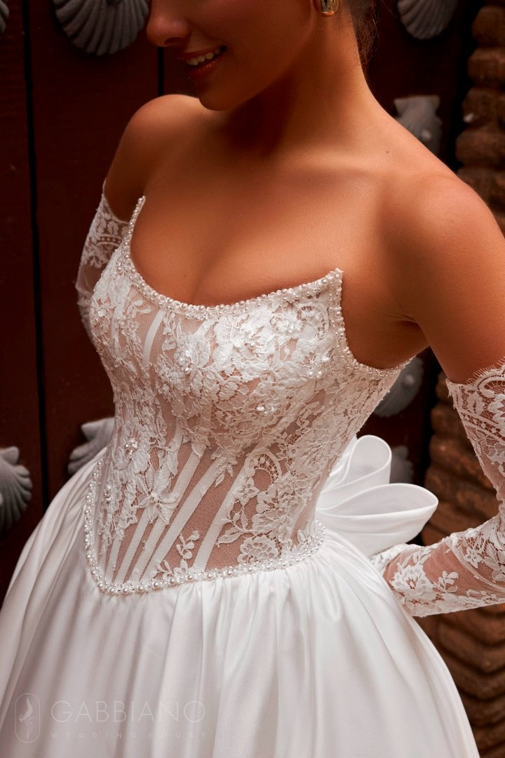 Close-up of Parish gown bodice with floral lace and pearl detailing