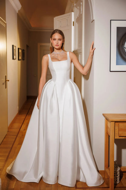 Cappella modern satin ball gown wedding dress featuring dramatic side pleats and structured waist