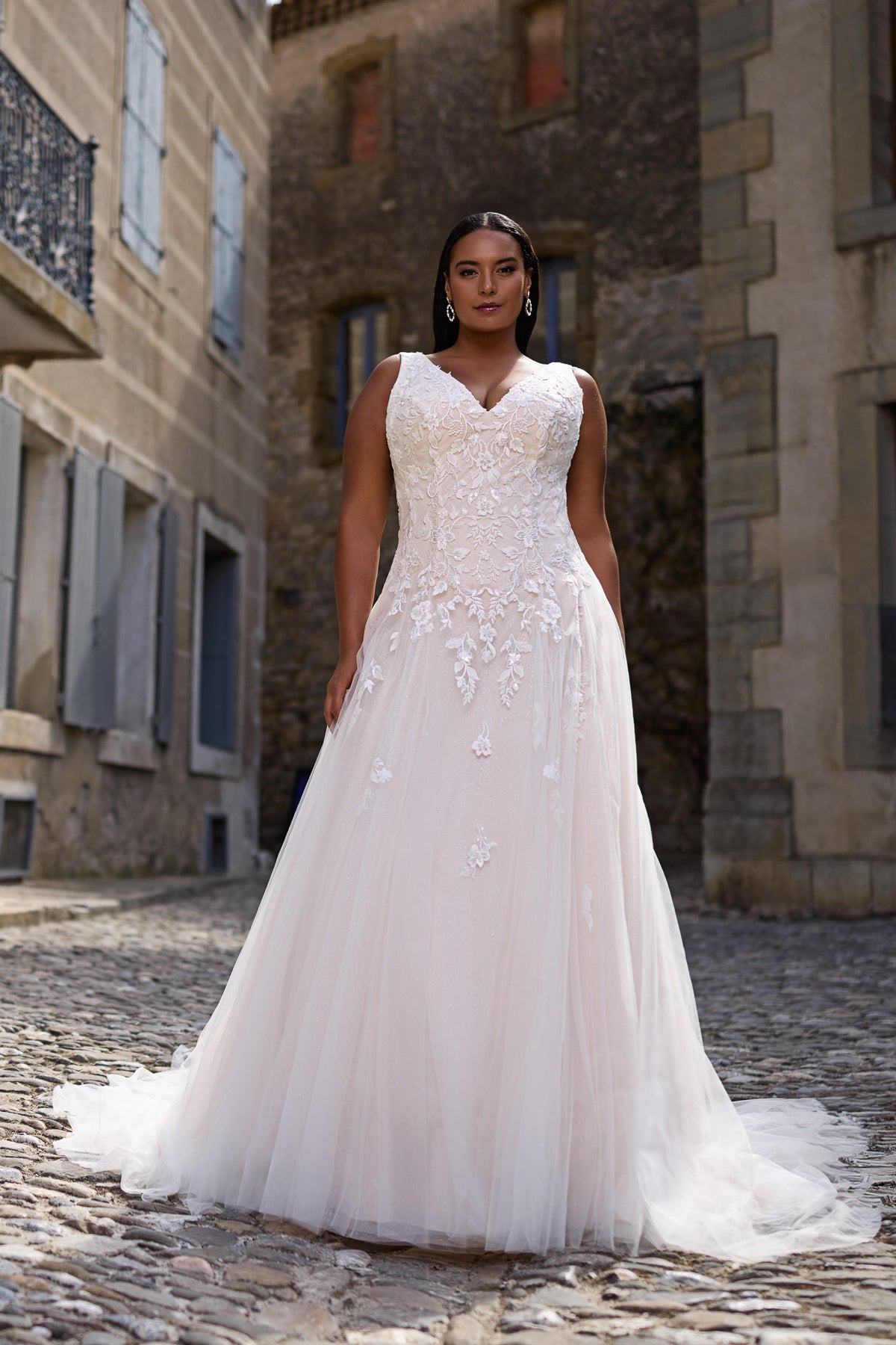 Orlena by Très Chic plus size A-line wedding dress with V-neckline, floral lace bodice and cascading lace appliqués