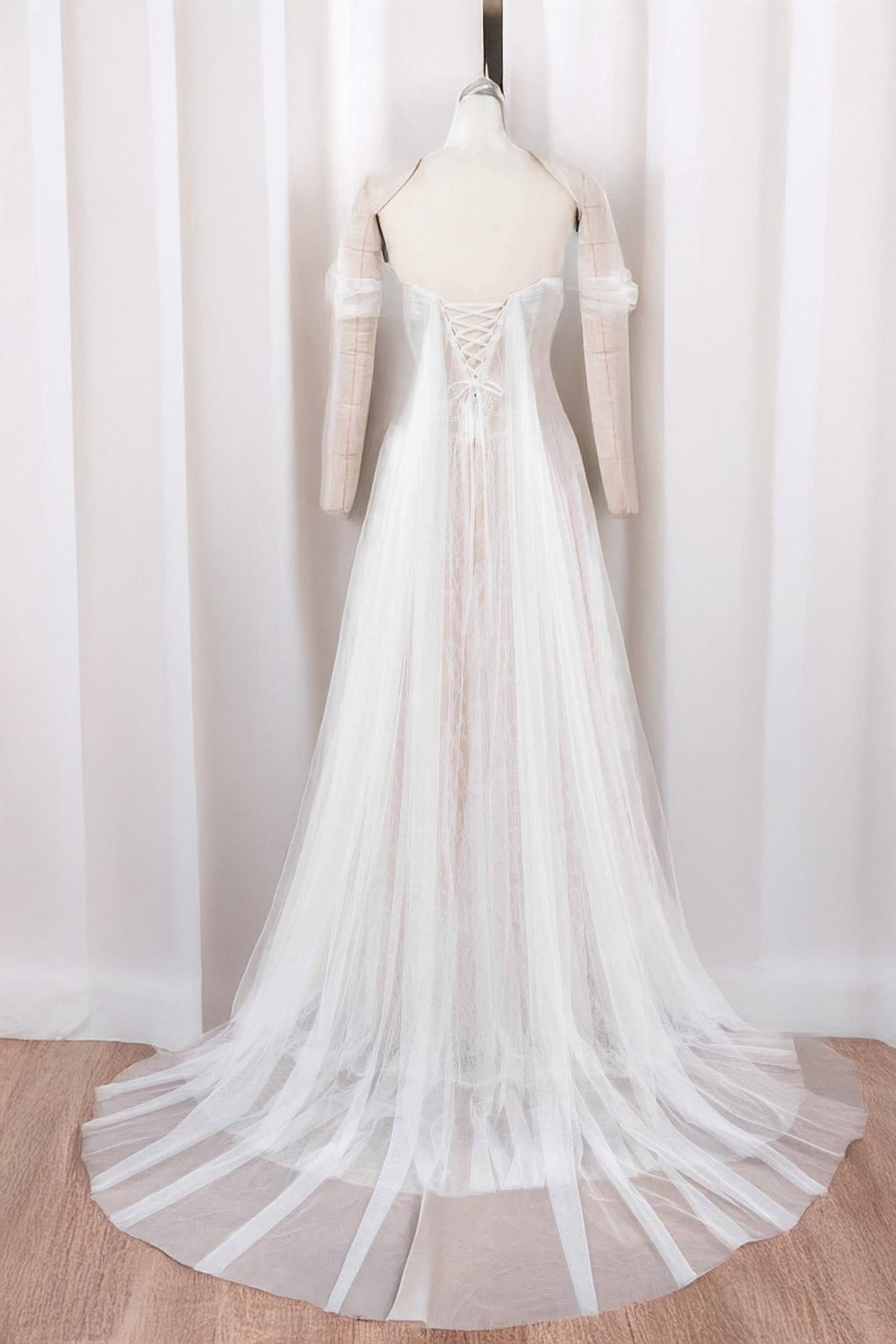 Mia drop-waist tulle A-line wedding dress with lace-up back, sweep train and airy panels — back view in light ivory