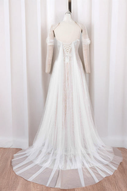 Mia drop-waist tulle A-line wedding dress with lace-up back, sweep train and airy panels — back view in light ivory