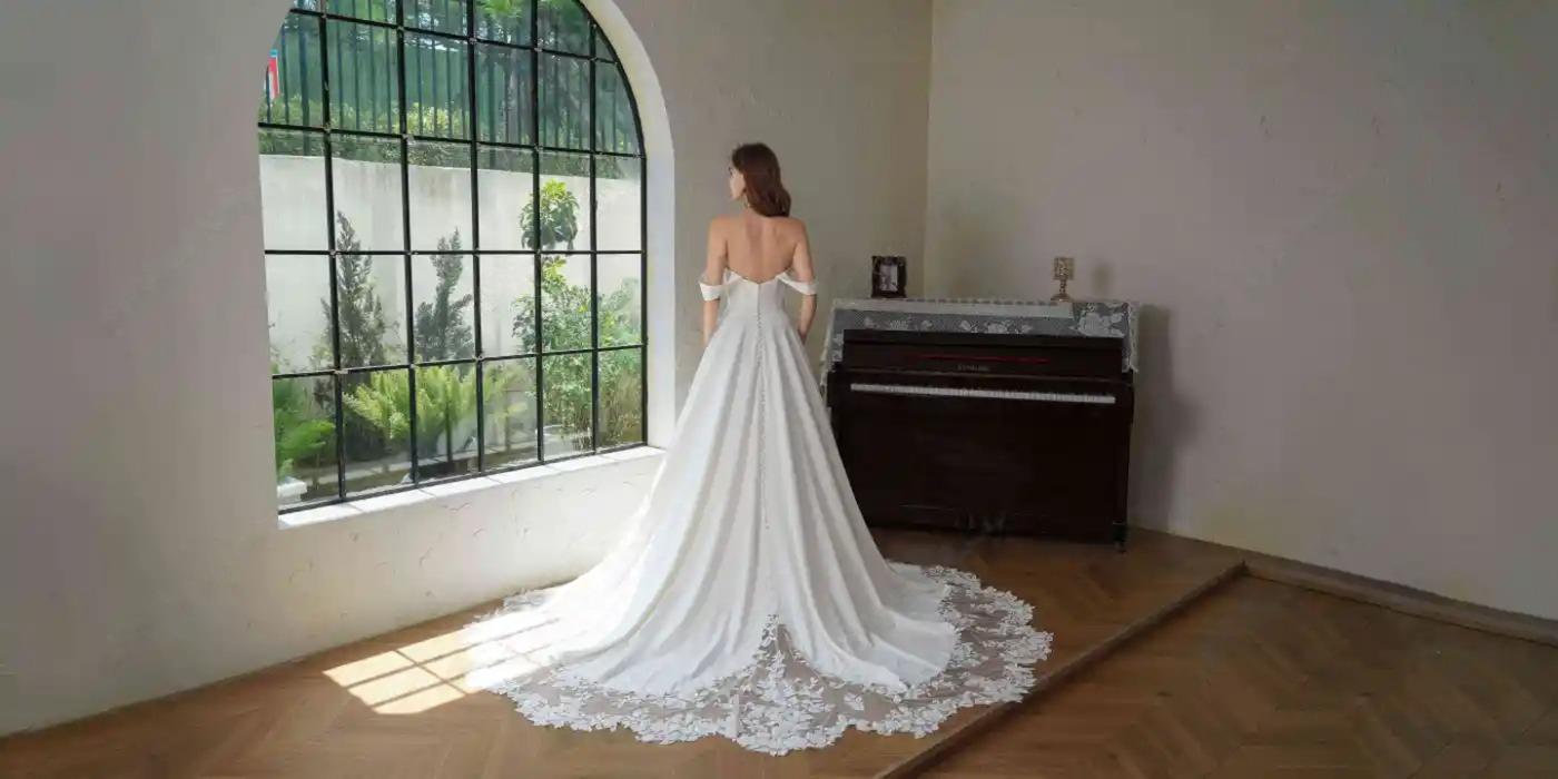Hélène wedding gown—back view with lace cathedral train and buttons