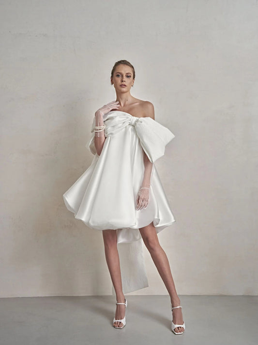 Front view of Adora dress featuring straight corset neckline, large bolero bow and tulip skirt in couture silhouette.