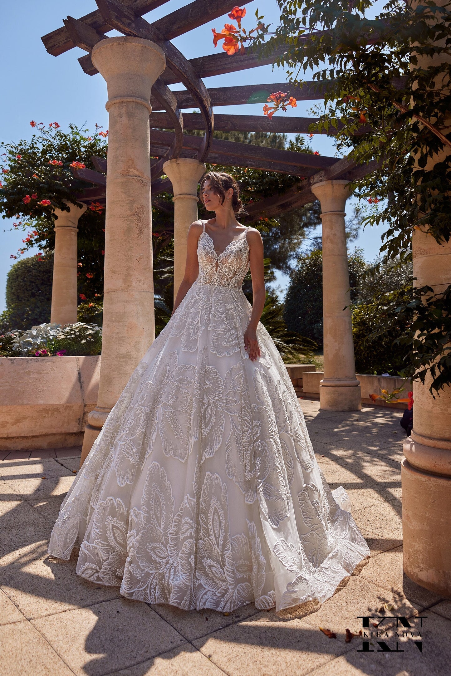 Kira Nova Maria wedding gown – strapless illusion bodice with floral embroidery, full ball gown skirt with lace appliqués and long train