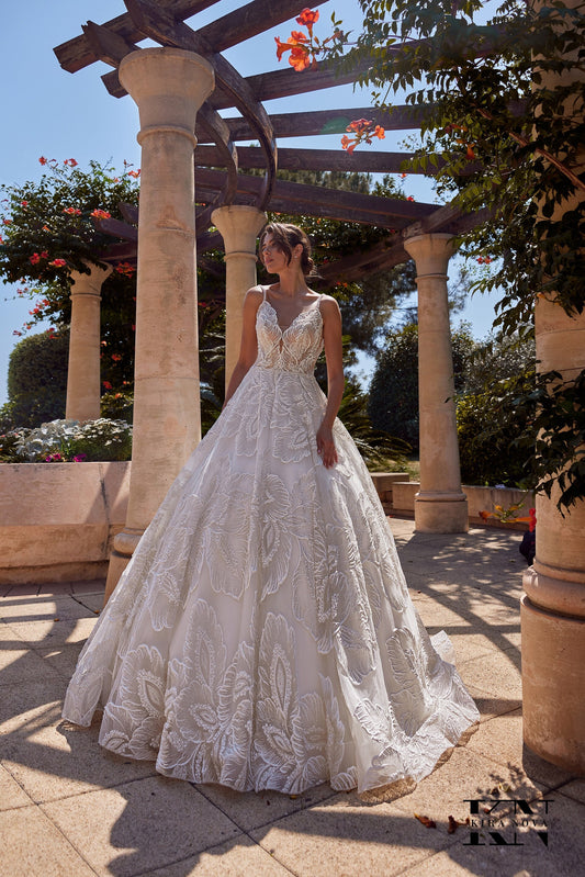 Kira Nova Maria wedding gown – strapless illusion bodice with floral embroidery, full ball gown skirt with lace appliqués and long train