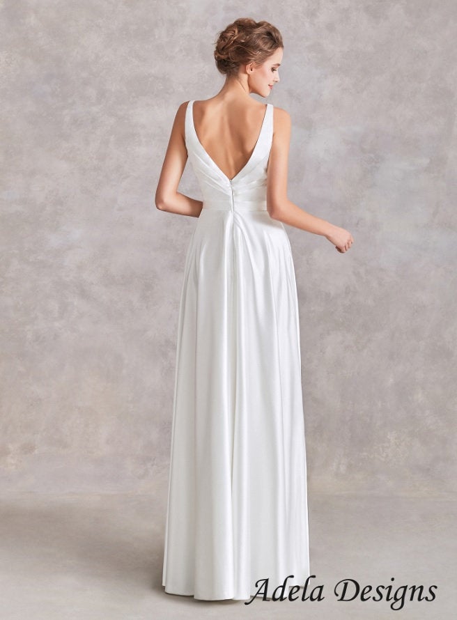 Back view of Winona wedding dress showing low V-back design and flowing satin skirt